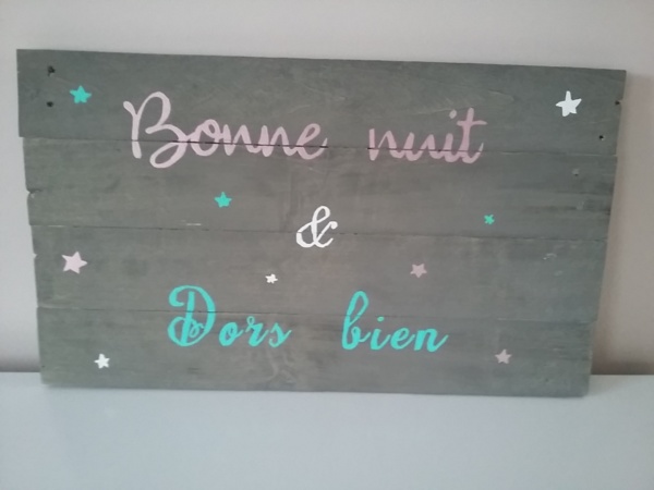 cadre en bois de palette pour chambre d'enfant peint en gris avec inscriptions aux couleurs douces