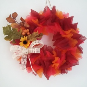couronne de noël en tissus voilage couleur rouge et couleur orangé avec feuilles d'automne