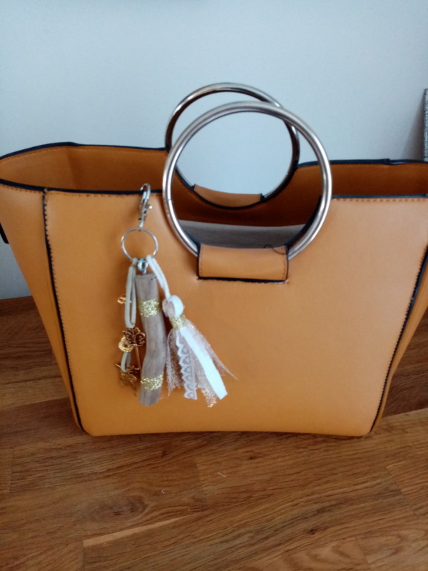 Bijoux de sac avec bois flotté, perles, ornement et pompon tissus, couleur or.
