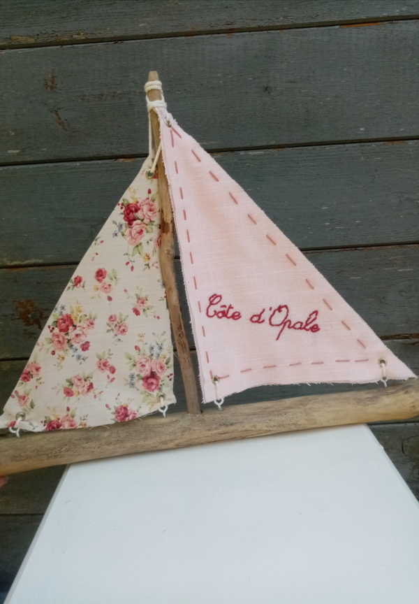 Bateau en bois flotté avec deux voiles. Une voile en tissus rose pale avec inscription Cote d'Opale en broderie fait main et l'autre voile en tissus fleuri